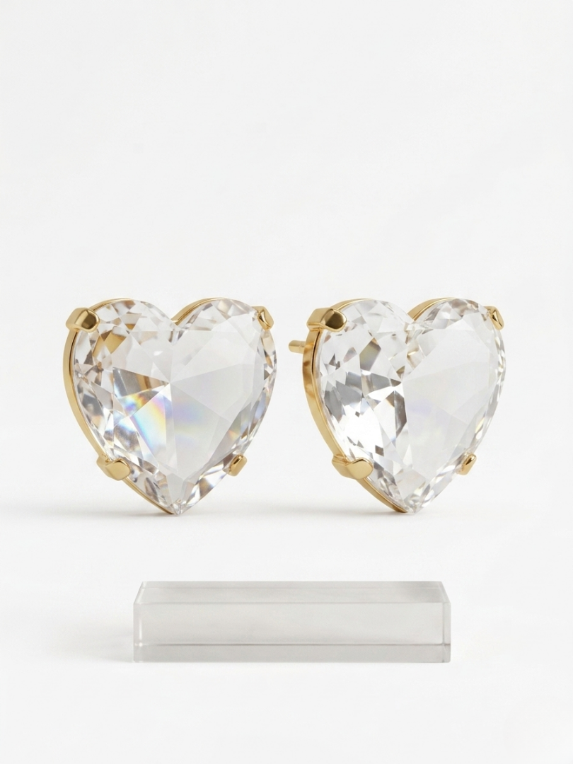 Pendientes maxi de corazón transparente con brillo irisado y acabado dorado para invitadas.