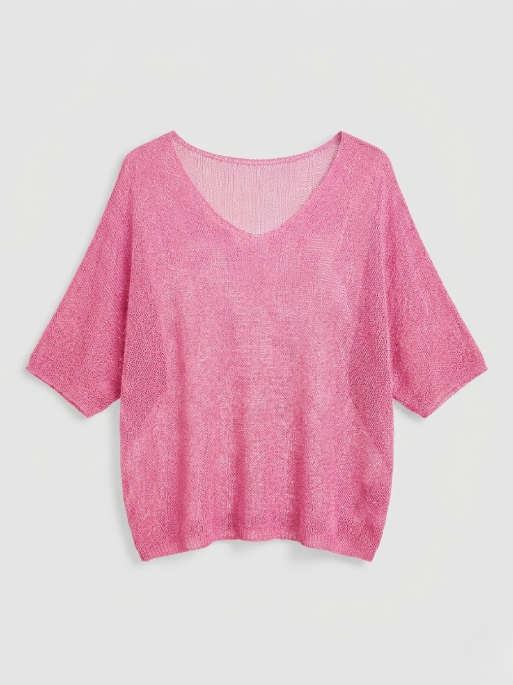 Jersey de punto calado en color rosa chicle con alta transparencia para combinar.