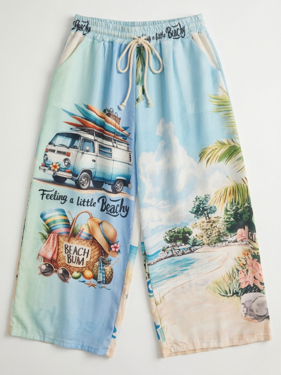 Frontal del pantalón fluido con diseño asimétrico de furgoneta vintage y paisaje tropical.