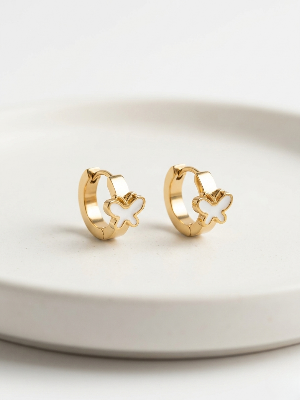 Pendientes de aro pequeños dorados con detalle de mariposa blanca esmaltada de Angel Salvaje.