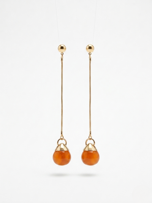 Pendientes de fiesta largos con piedra color ámbar y cadena fina dorada para looks elegantes.